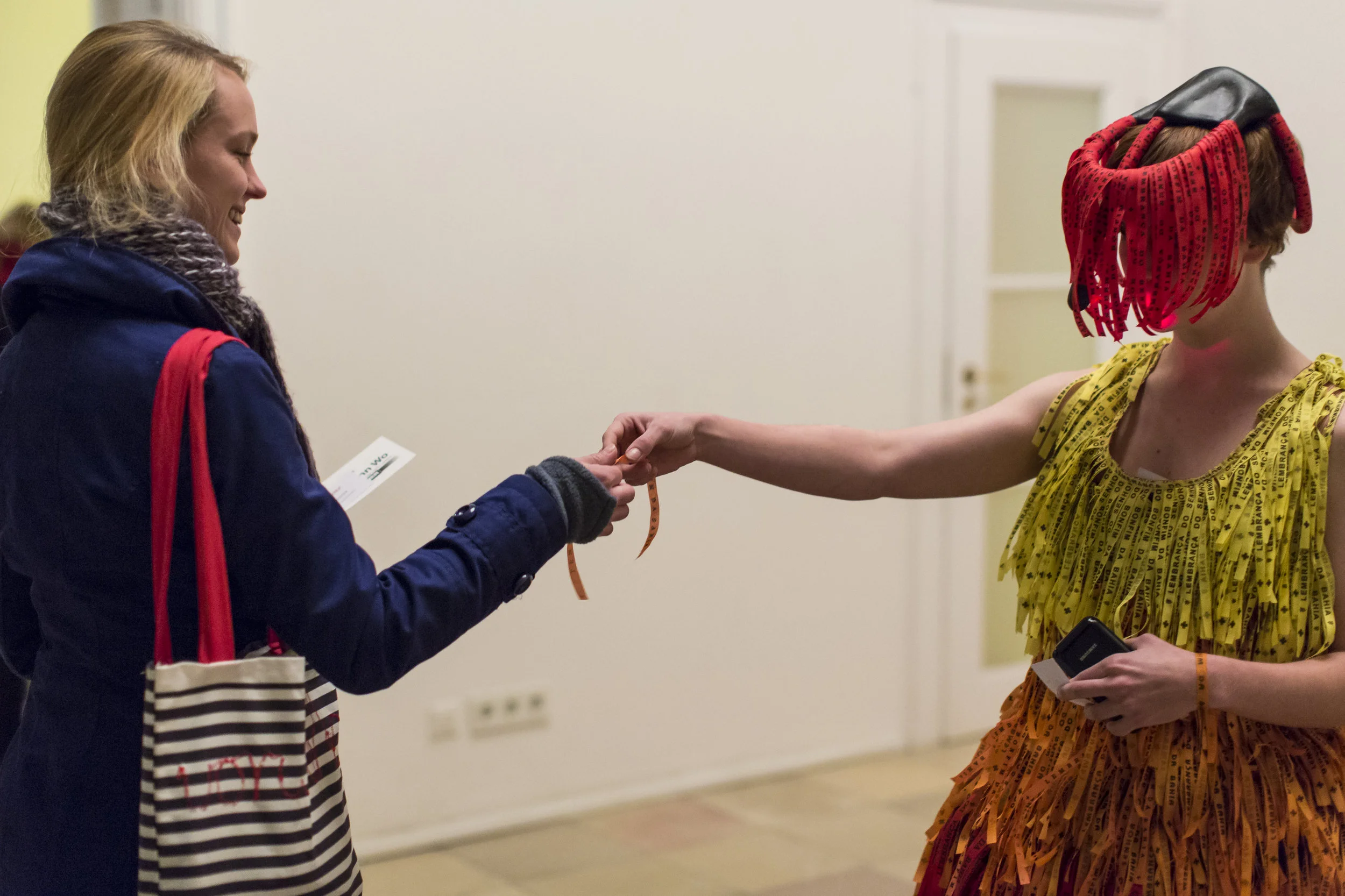 An audience member reaching towards the performer wearing e-Ansã
