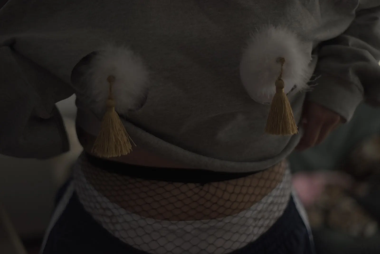 Close view of the two feathered cups and gold tassels of the Lazy Burlesque Bra