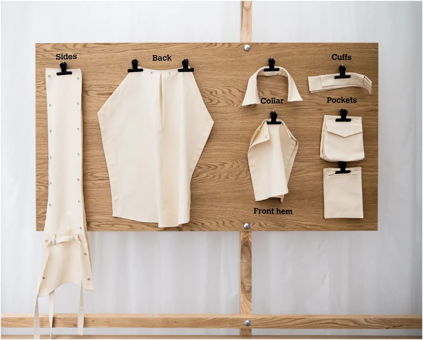 A participant selecting modular shirt components from a wooden display