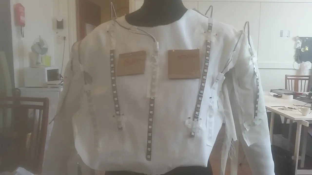 Front view of a white Human Sensor LDN wearable prototype with an integrated LED strip