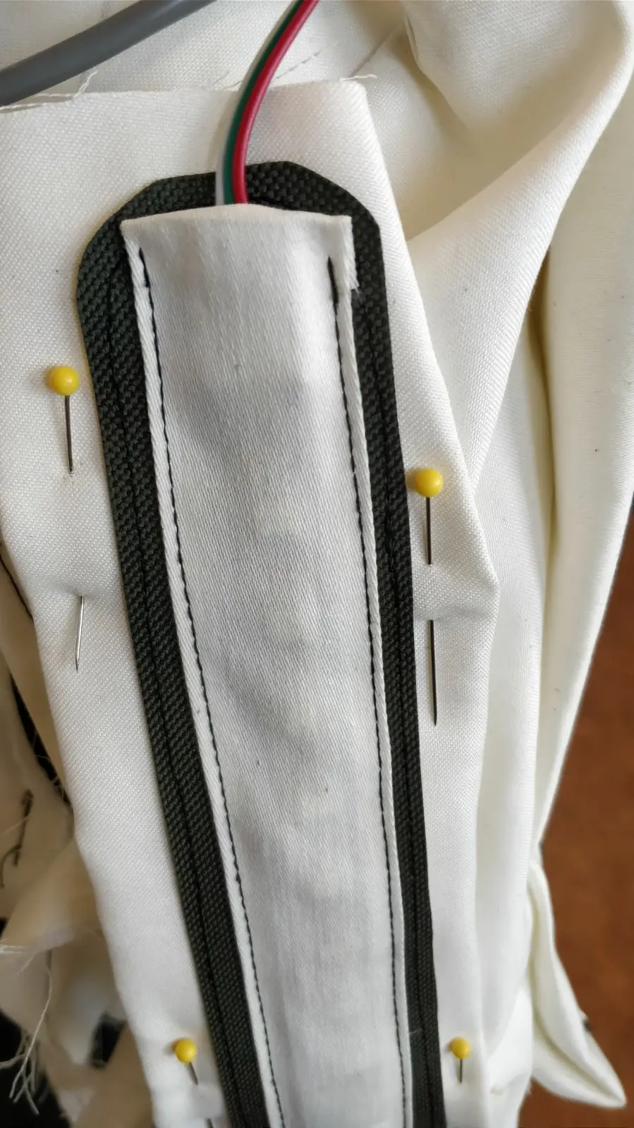 Close view of a textile channel carrying electronics inside a Human Sensor costume