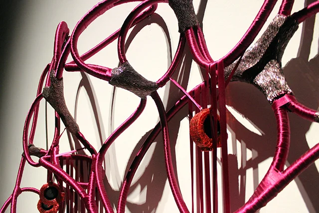 Detail of the sculpture’s wrapped loops, beads, ribbons and embedded electronics