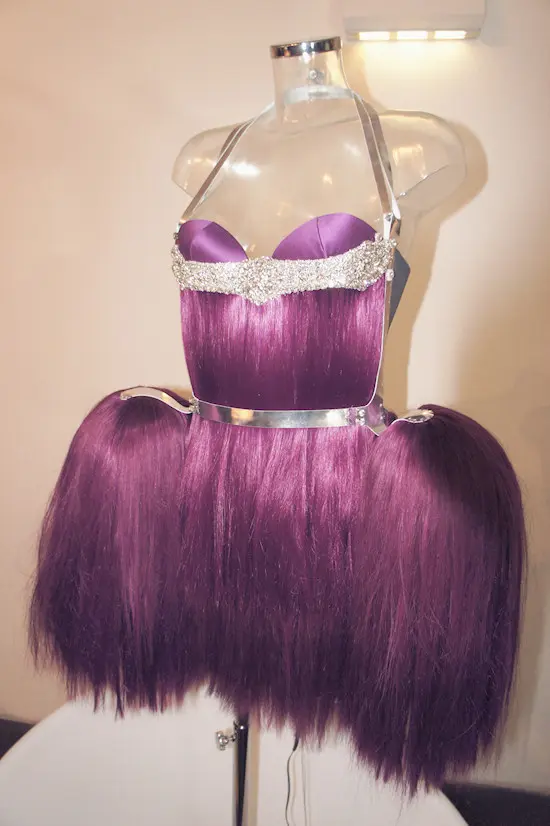 The violet-haired Untangle Me dress displayed on a transparent mannequin at the TECHNOSENSUAL exhibition